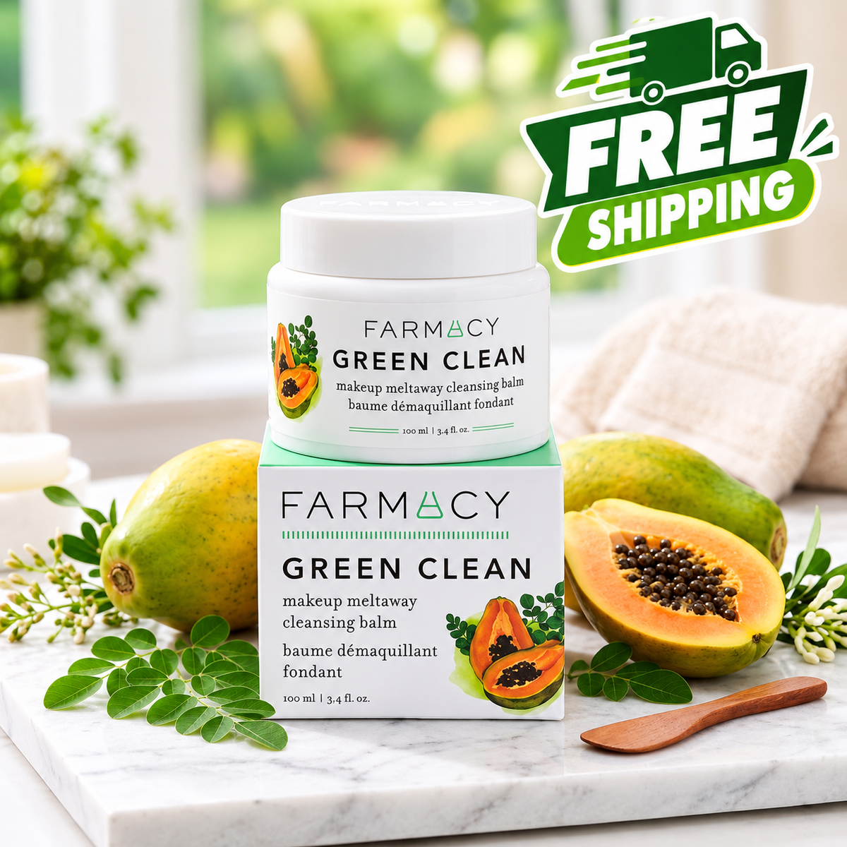 A jar of FARMACY Green Clean makeup meltaway cleansing balm is displayed on a white marble surface, stacked on top of its retail box. The scene is styled with fresh papayas, green leaves, and a wooden spoon, with a 'FREE SHIPPING' promotional badge in the upper right corner.